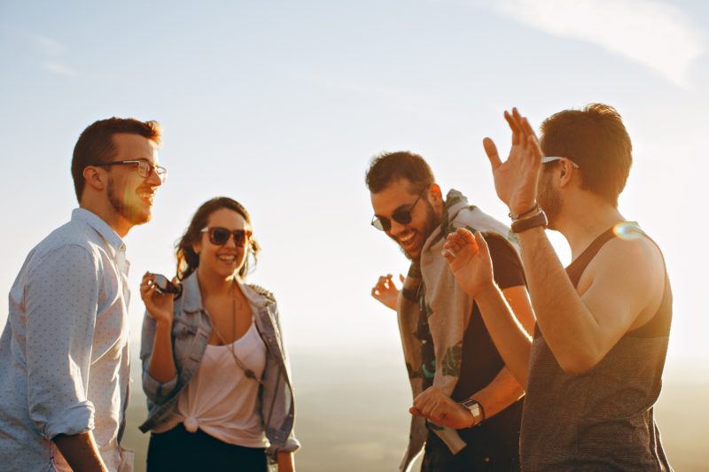 Group of people smiling and looking happy.