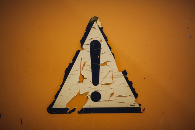 Exclamation caution symbol in yellow triangle.