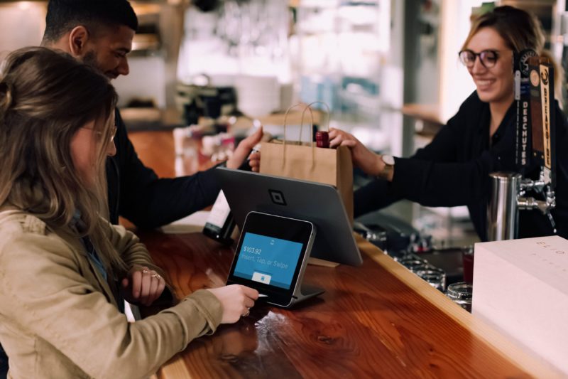 Person inserting their card to pay at POS station in a shop