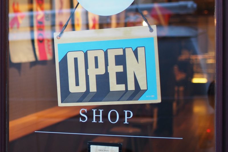 Front glass door of a shop, with an open sign on the glass